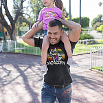 dadacorn-dad-daughter-unicorn-dad-and-daughter-wearing-t-shirts-mockup-at-a-park