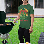 world-dopest-dad-funny-dad-saying-father's-day-t-shirt-mockup-of-a-man-with-a-dad-hat-grilling-at-a-bbq-party
