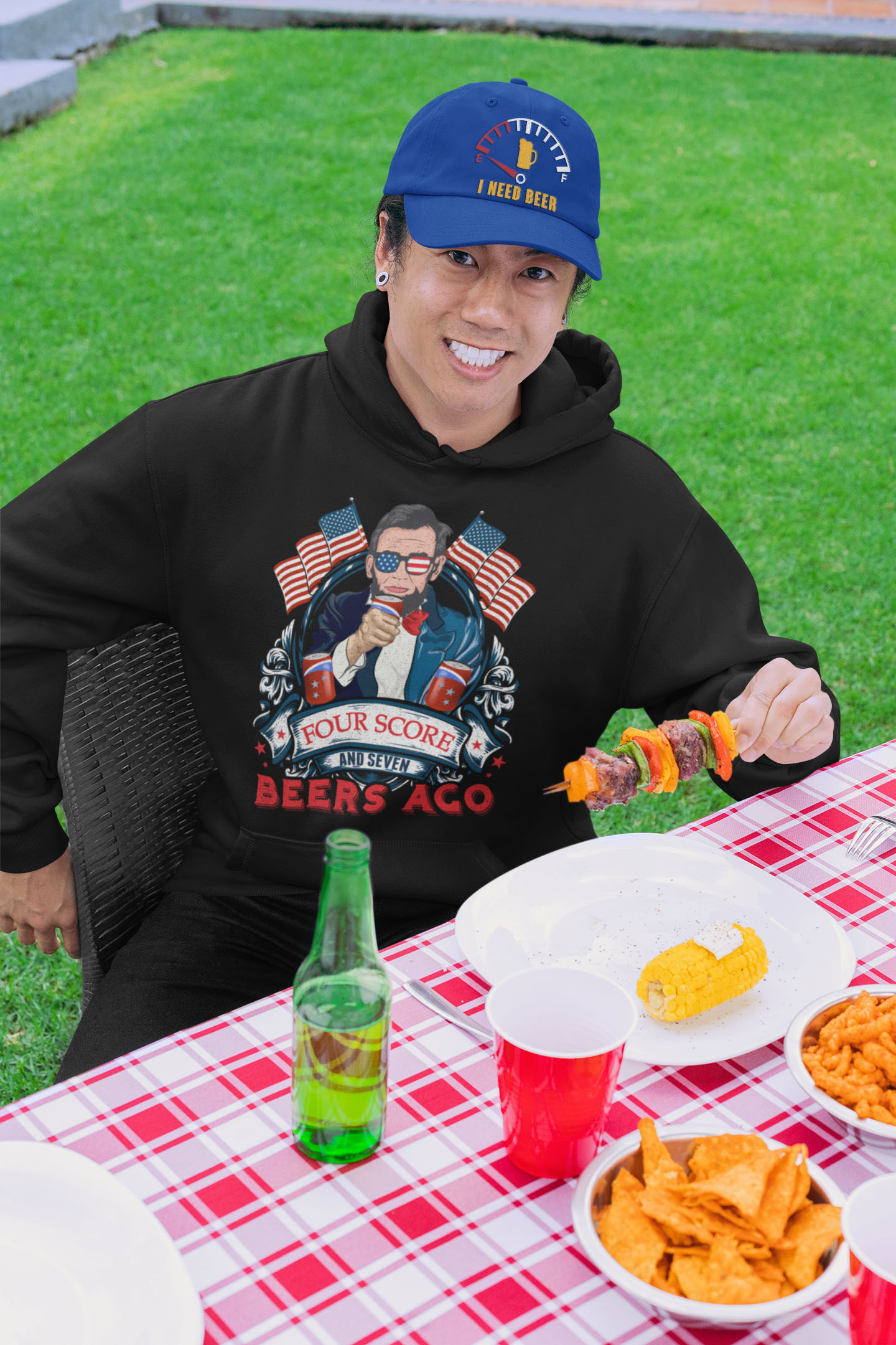 Four Score And Seven Beers Ago Fourth Of July Hoodie Shirt- 4th July American USA Flag Patriotic Gift T-Shirt-pullover-hoodie-mockup-of-a-man-wearing-a-dad-hat-at-a-bbq-party